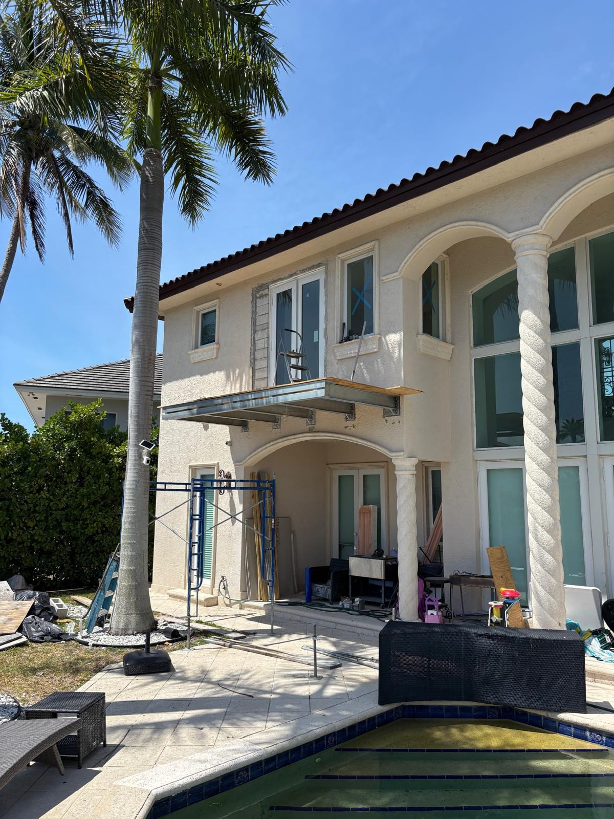 Rear elevation with columns, arches, and the new balcony above the screened pool